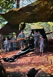 A French battery of heavy guns under camouflage netting in the forest, Verdun, September 1916